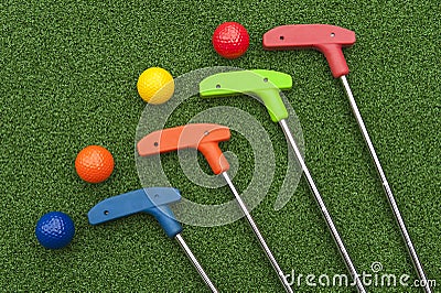 Four Mini Golf Putters and Balls Stock Photo