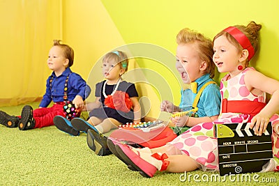 Four mods children sit at the bright Stock Photo