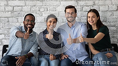 Four multiethnic persons job seekers showing thumbs up being hired Stock Photo