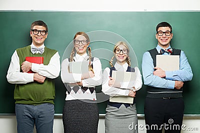 Four nerds in front of blackboard Stock Photo