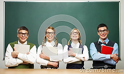Four nerds holding books Stock Photo