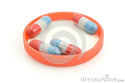 Four Oblong Pills in Cap Stock Photo