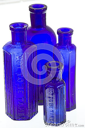 Four old blue glass medicine bottles Stock Photo