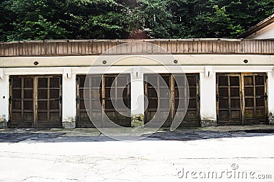 Four old garage doors in the ancient grunge building in the abandoned city Stock Photo