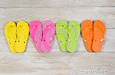 Four pairs of New Sandals on faded white wood Stock Photo