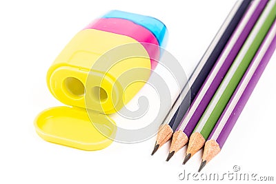 Four pencils and a multi-colored sharpener Stock Photo