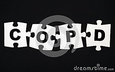 Four pieces of puzzle with letters COPD. Black background Stock Photo