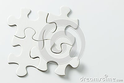 Four pieces of white jigsaw puzzle Stock Photo