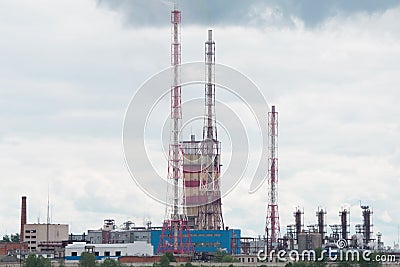 The four pipes of the heat station smoke early in the morning against the blue sky. Stock Photo