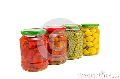 Four potted vegetables glas jars isolated on white Stock Photo