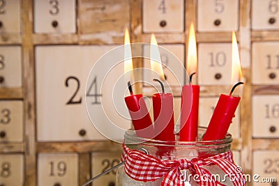 Four red burning advent candles with calendar. Stock Photo