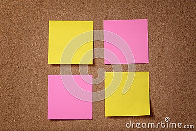 Four reminder sticky notes on cork board Stock Photo