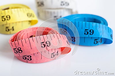 Four roll of colorful measuring tapes Stock Photo