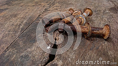 Four rusty bolts on ancient wood Stock Photo