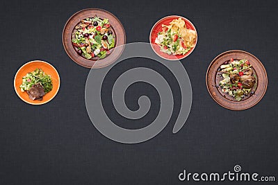 Four salads on a black background lie in a semicircle with sopy space Stock Photo