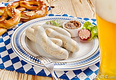 Four sausages with dipping sauce, pretzel and beer Stock Photo