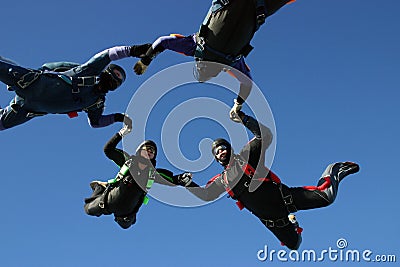 Four skydiver form a circle Stock Photo