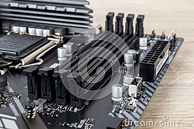 Four slots for ddr4 ram memory modules on a modern black pc motherboard. Computer mainboard circuit components. Desktop hardware Stock Photo
