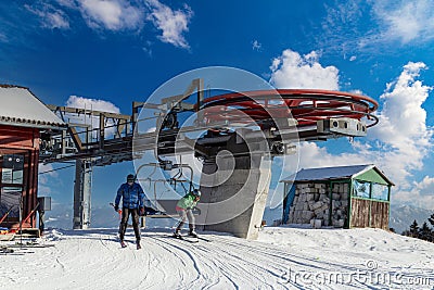 Four snowboarders descend to the ski chairlift Editorial Stock Photo