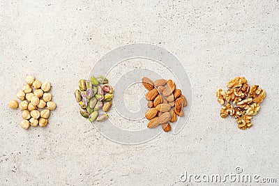 Four sorts of organic nuts: hazelnuts, pistachios, almonds, walnuts. Flat lay, top wives, copy space. Stock Photo