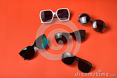 Four sun various glasses on live coral background. Travel concept Stock Photo