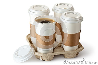 Four take-out coffee in holder. One cup is opened. Stock Photo