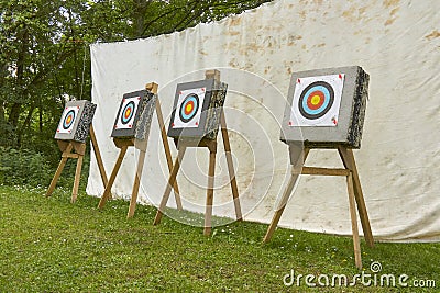 Four targets in a row for archery in front of a stretched canvas Stock Photo