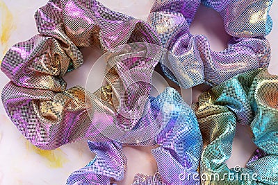 Four trendy holographic scrunchies on pink background Stock Photo