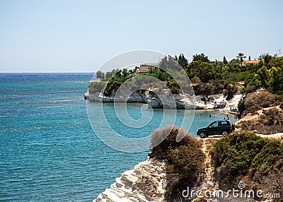 A four wheel drive car dangerously parked next to steep cliff at Governor`s beach, Cyprus Stock Photo