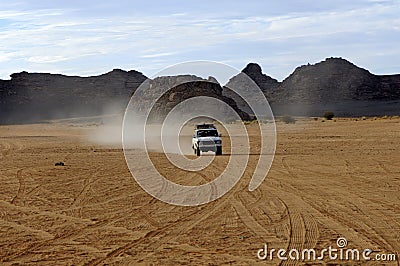 Four-wheel drive jeep on a desert road Stock Photo