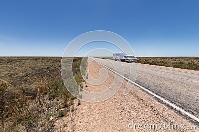 Four wheel drive vehicle and large caravan parked by the side of a road. Stock Photo