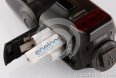Four white batteries eneloop in flash canon isolated close up Editorial Stock Photo