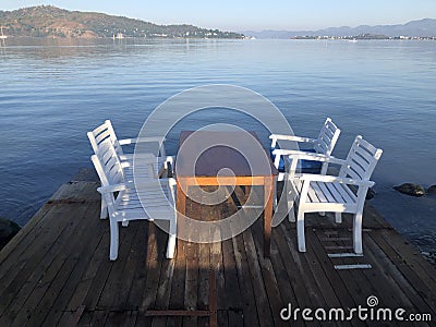 Four White Chairs and a Table Stock Photo