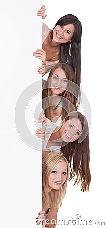 Four women peering at a blank sign Stock Photo