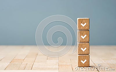 Four wooden blocks stacked with check marks. Concept of task completion, checklist, and progress. productivity, goal Stock Photo