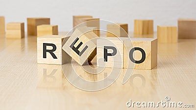 four wooden blocks with text REPO on table. copy space. white background. Stock Photo