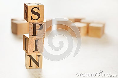 Four wooden cubes arranged in stack with word SPIN meaning Solution Problem Implication Need on them, space for text / image at Stock Photo