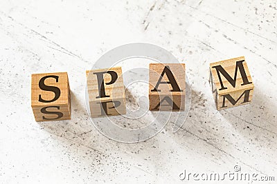 Four wooden cubes with word SPAM on white working board Stock Photo