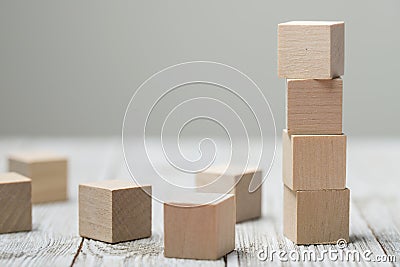 Four wooden toy cubes on grey wooden background Stock Photo