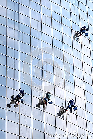 Four workers washing windows Stock Photo