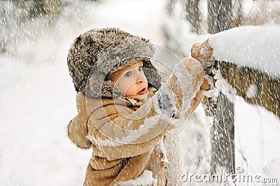 Boy alone in the winter in the forest Stock Photo