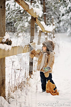 Boy alone in the winter in the forest Stock Photo