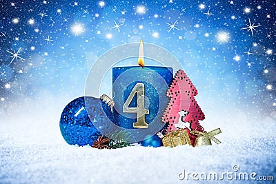 Fourth sunday of advent blue candle with golden metal number red decoration one on wooden planks in snow front of silver panorama Stock Photo