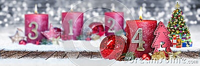 fourth sunday of advent red candle with golden metal number one on wooden planks in snow front of silver bokeh background Stock Photo