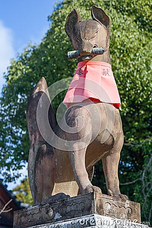 Fox statue at the main gate of Fushimi Inari Shrine. Foxes are thought to be Inari`s messengers. Editorial Stock Photo