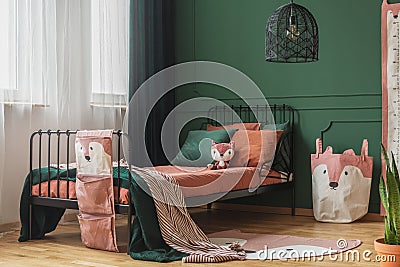 Fox theme in cute bedroom interior with green wall and orange bedding Stock Photo