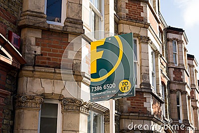 Foxtons Estate agent sign outside a row of Victorian terraced houses Editorial Stock Photo