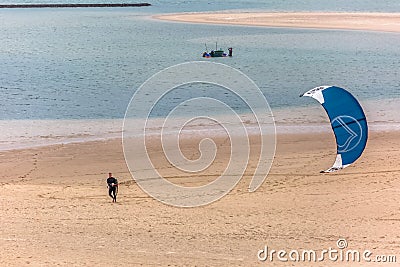 View of a male professional Kiteboarder walking on the sand beach, at the Obidos lagoon Editorial Stock Photo