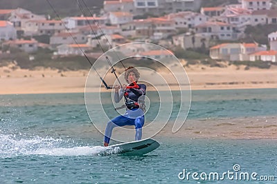 View of a professional sportsman practicing extreme sports Kiteboarding at the Obidos lagoon, Foz do Arelho, Portugal Editorial Stock Photo