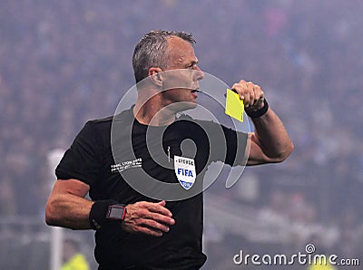 Dutch FIFA referee Bjorn Kuipers shows a yellow card Editorial Stock Photo